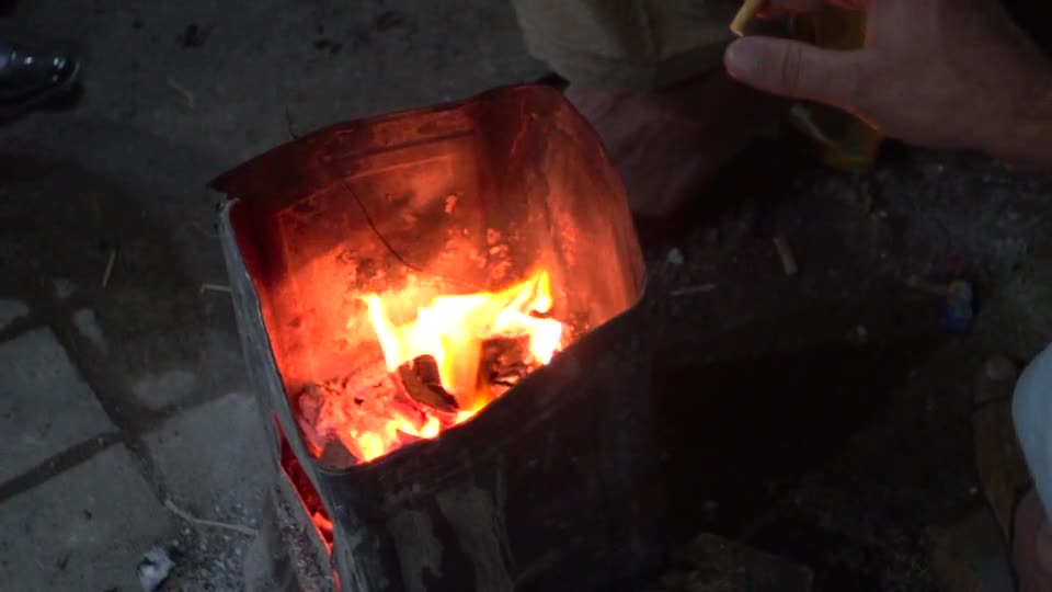 Close-Up View of a Person Smoking by the Fire Pit