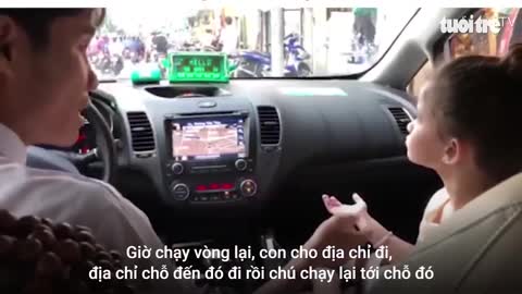 A girl who works as an interpreter for her mother when taking a taxi in Vietnam