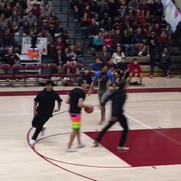Teen in wetsuit shoots free throws in a gymnasium