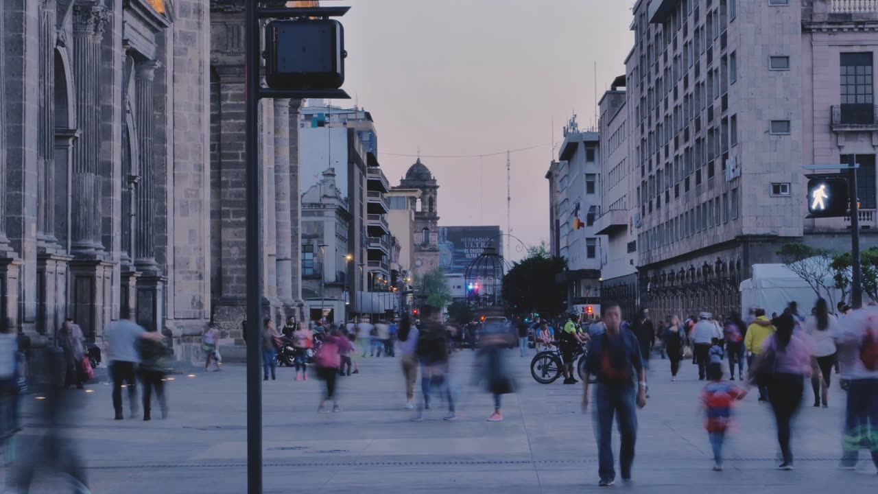 Street with people walking at dusk