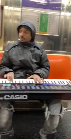 Man black jacket playing casio piano