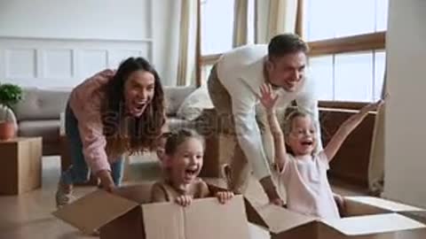Excited happy young parents run push cardboard