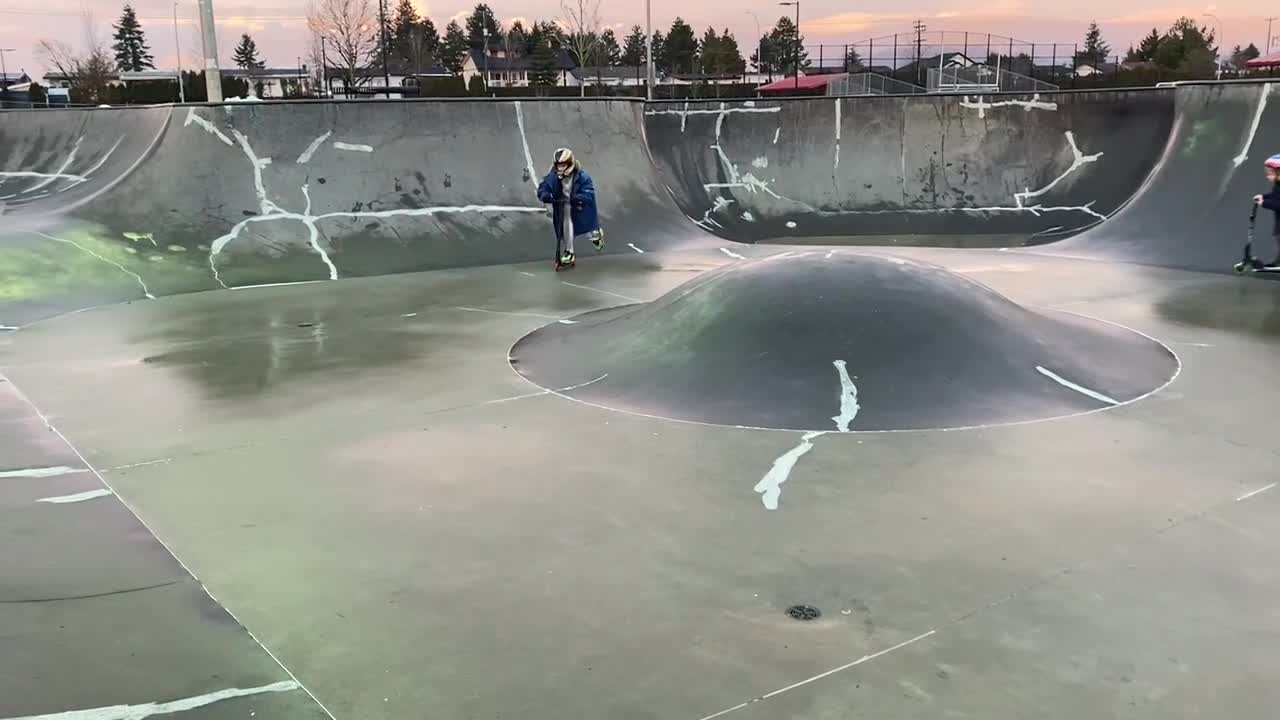 Little skate park scooter riding