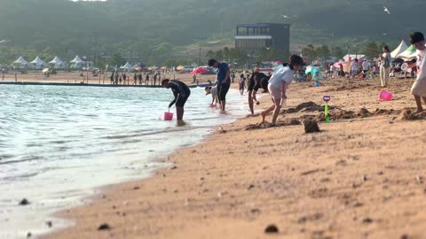 People enjoying their holidays at a beach in Incheon, South Korea, on June 18, 2023