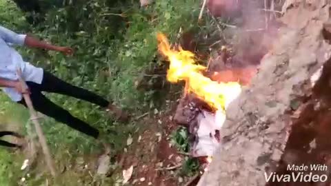 Guy swings in branch falls on fire