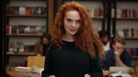 portrait of an attractive long red-haired European girl student standing in high