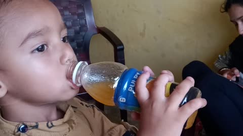 Kid drinks orange juice