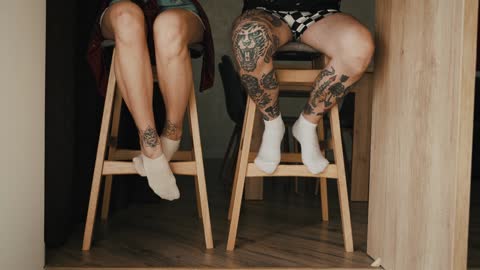 Guy and Girl Sitting Together and Shaking their Legs