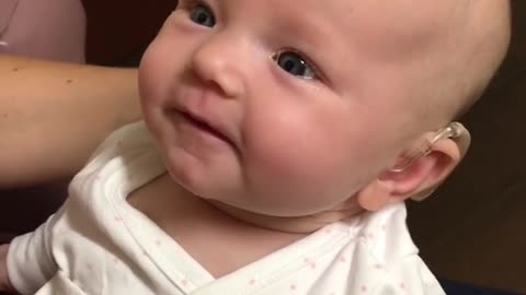 Cute baby hearing for the first time