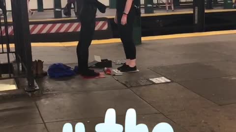 Woman and person in black costume stand off