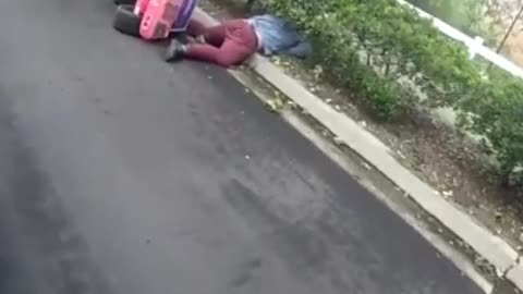 Man in pink toy jeep flips over