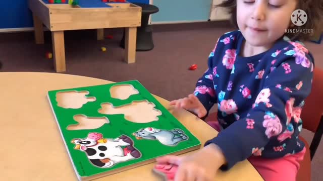 Mariam plays with her magnet animal toys