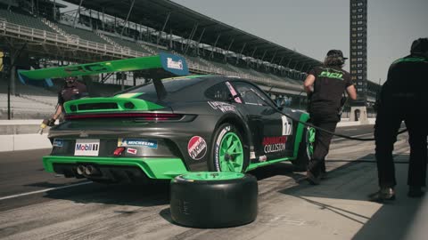 Crew replacing tires of race car