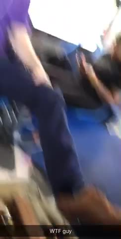 Guy with purple shirt foot on bus seat