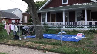 People bowling midget in front yard