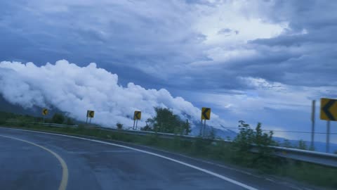 going-down-a-curved-highway-through-a-mountain-2K view On the road
