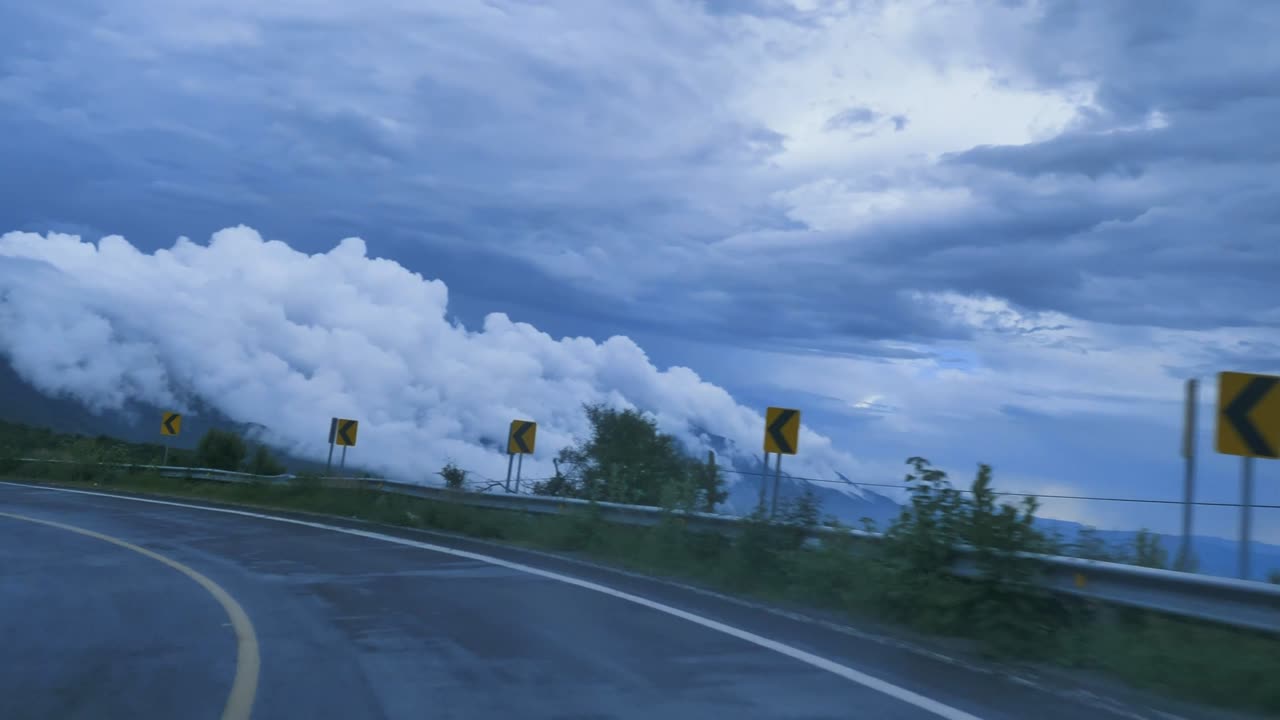 going-down-a-curved-highway-through-a-mountain-2K view On the road