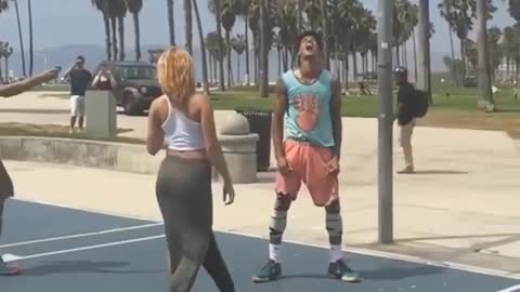 A man dunks a basketball court with a difficult technique and succeeds