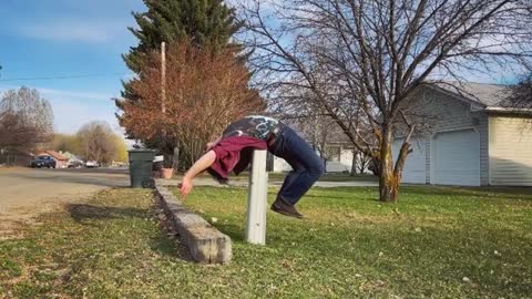 Man Performs Frontflip And Balances His Back On Small Pillar