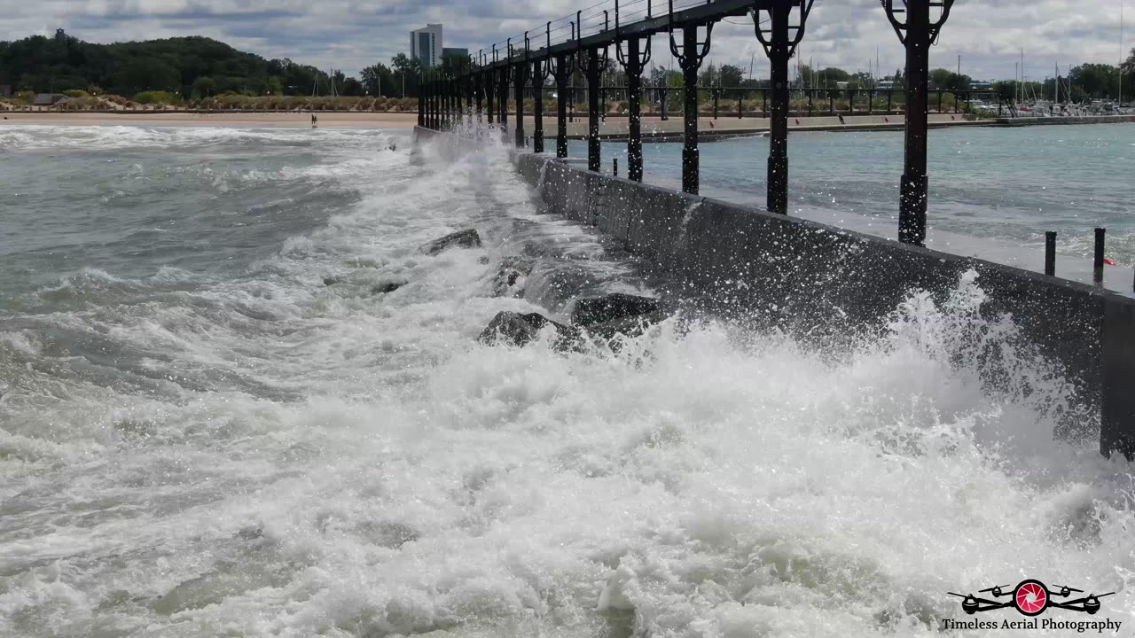 Flying Into Massive Waves Washing Over Lighthouse & Pier In Michigan City 4K Drone Footage