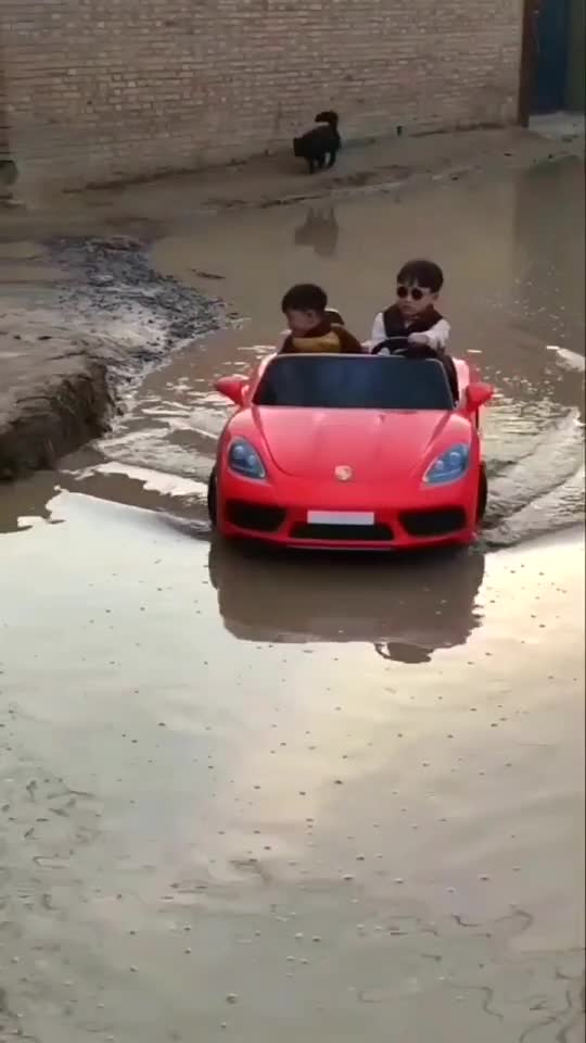 The cute baby drive mini Ferrari in water.