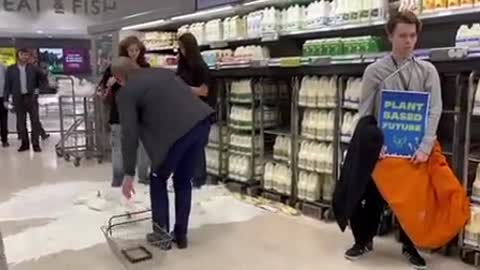 Environmental activists in UK pouring milk