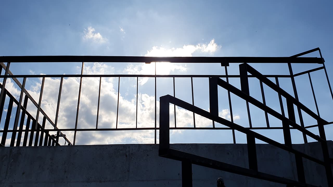 view of the sky with a railing