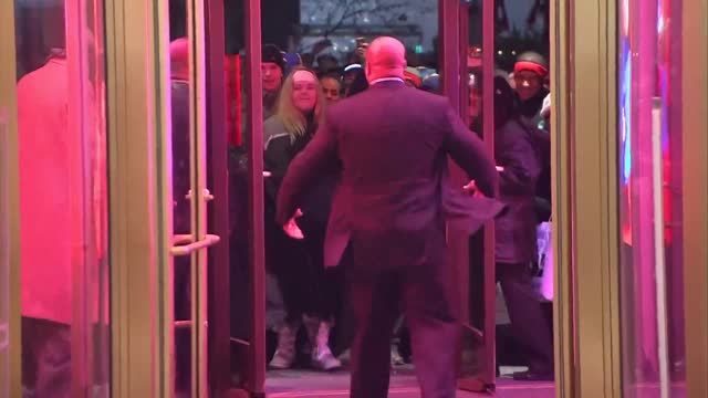 Shoppers waiting out in the rain for Black Friday deals