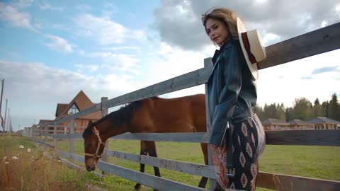 Stylish lady standing near horse