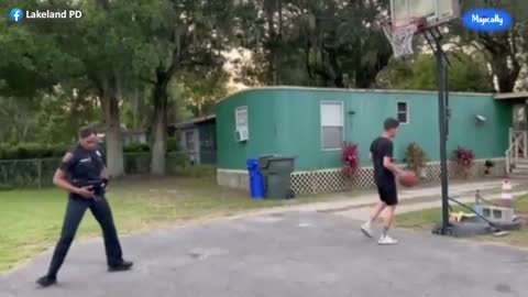 Female police officer schools local teen in game of one on one basketball