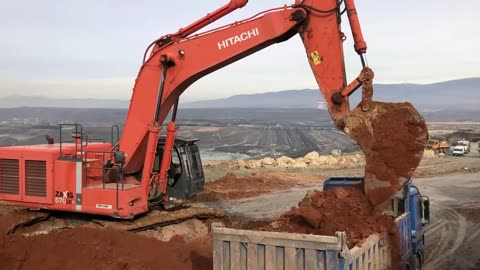 Hitachi Zaxis 670LCR Excavator Loading Mercedes And MAN Trucks - Operator Anogiatis