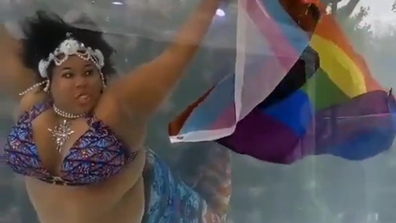 Proud Mermaid Wants to Demonstrate Its True Colors While Underwater with Pride Flag