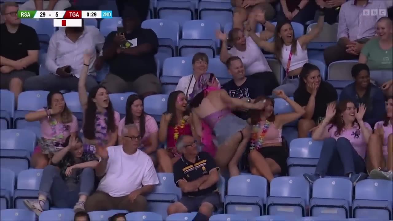 Woman in crowd shakes booty during Rugby sevens at the Commonwealth Games