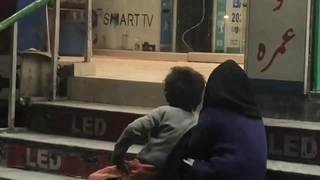 Poor kids watching cartoons outside of a shop🥺