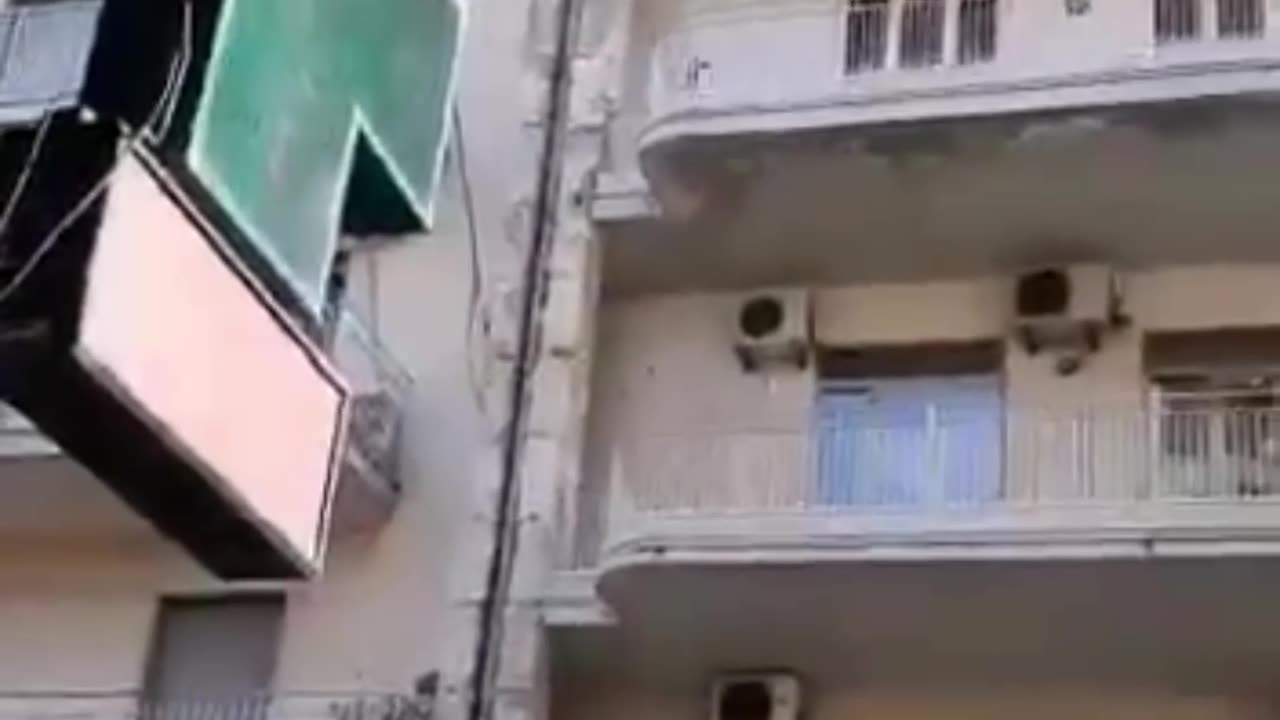 Chaos in Catania Sicily. A half-naked woman throws everything from the balcony