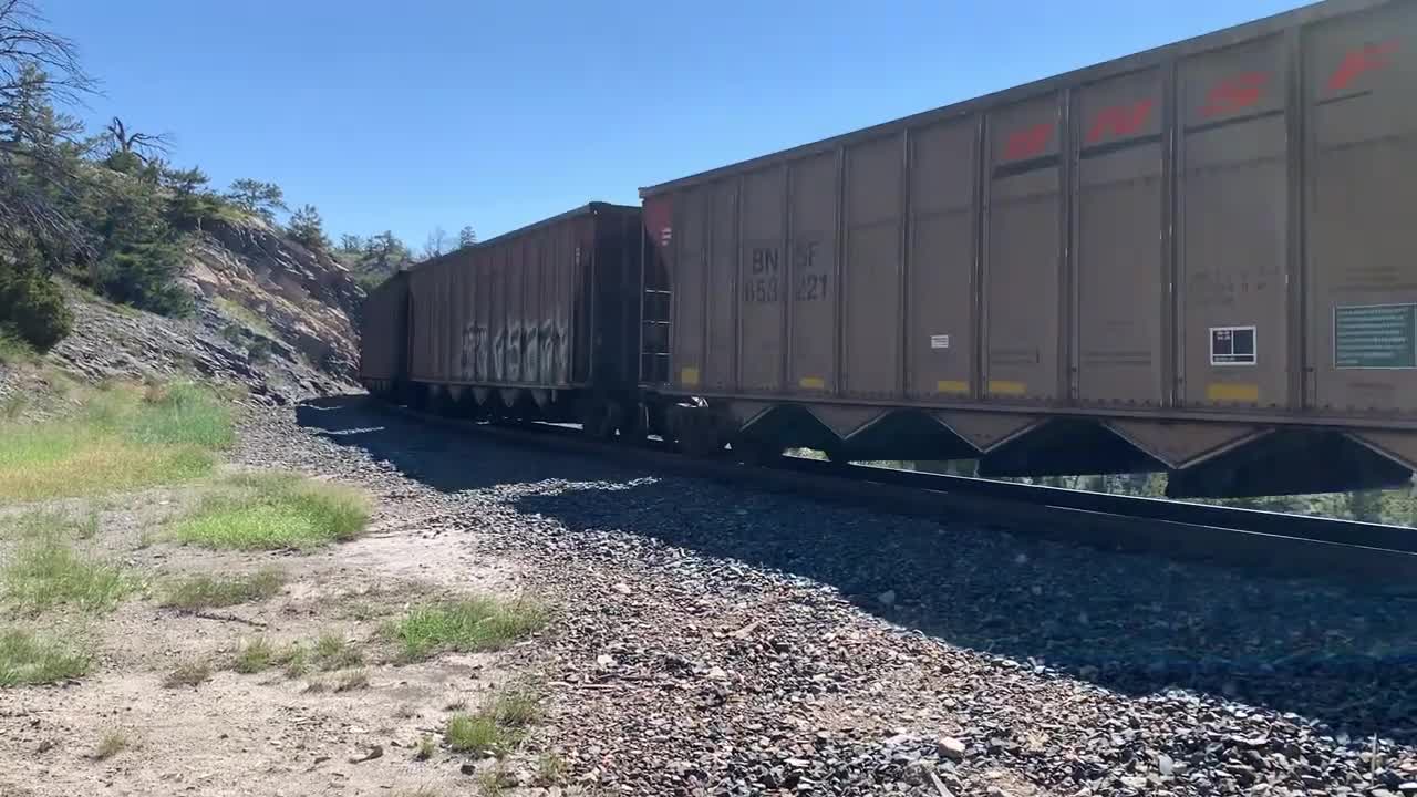 Solid EMD SD70ACe lineup up Mullan Pass. 3 BNSF, 4 MRL, then 1 BNSF on the rear.