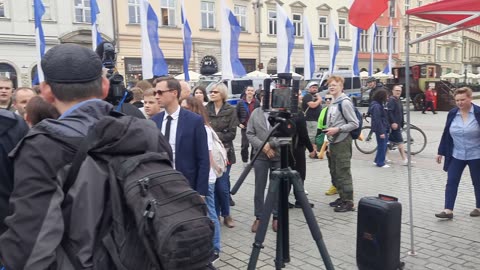 Queuing with fire extinguishers for Grzegorz Braun's signature, Old City's main square, Kraków