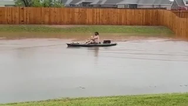 Guy Does Kayaking in his Backyard Waterlogged Due to Heavy Rain