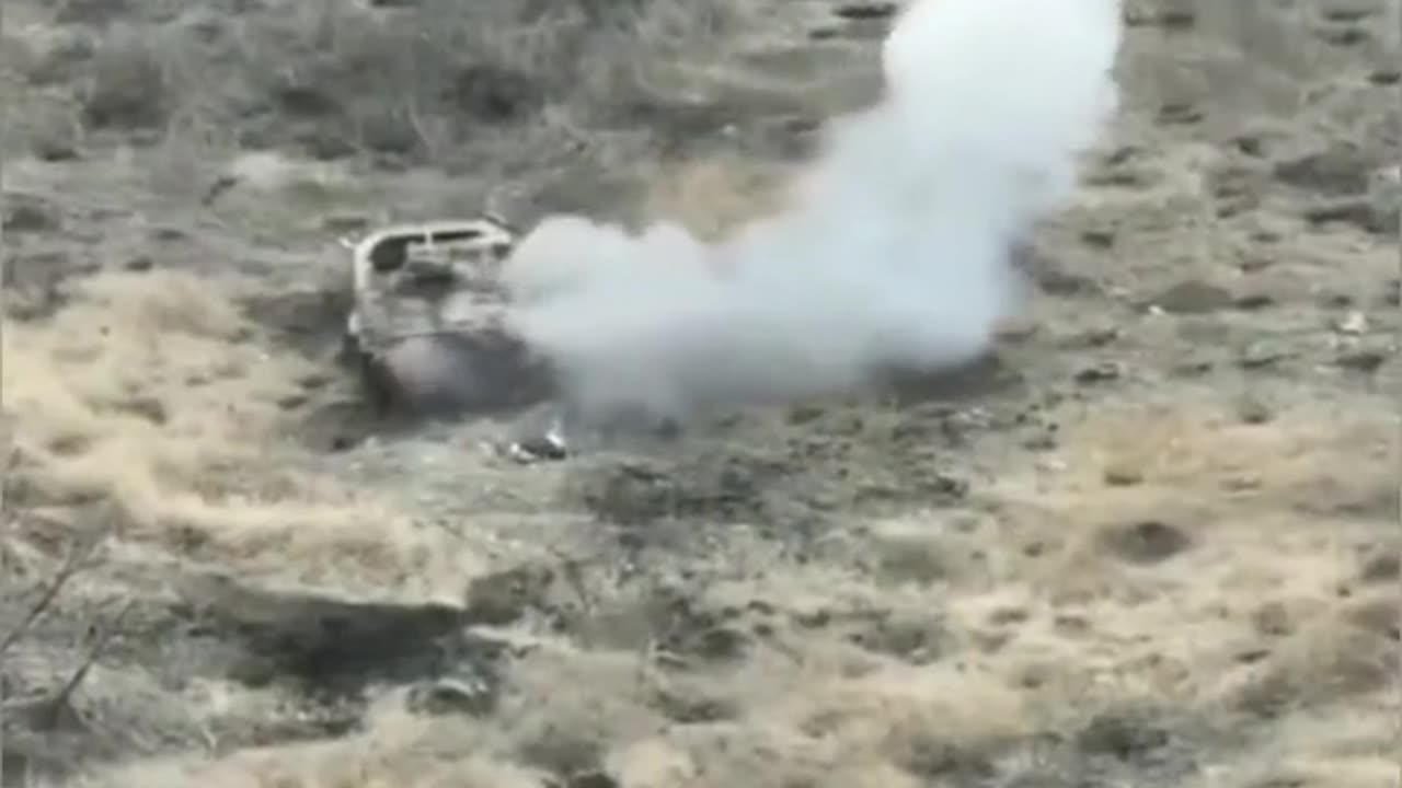 UA POV: Avdiivka. Ukrainian drone hits two Russian soldiers next to a destroyed armored vehicle.