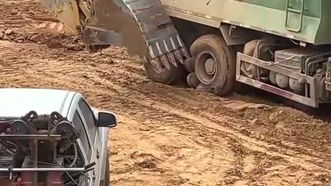 When the excavator is working, it accidentally digs the tire of the truck. How can I explain this?