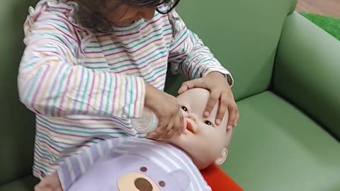 Aiza playing with doll