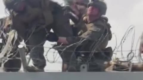 Desperate Afghans pass baby over razor wires to U.S. soldiers
