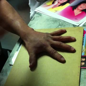 Playing a dangerous game with a knife.