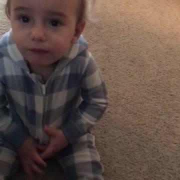 Baby can't find ball in his Onsie