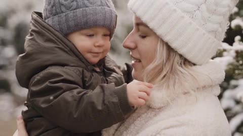 A Woman Kissing and Playing with her Baby