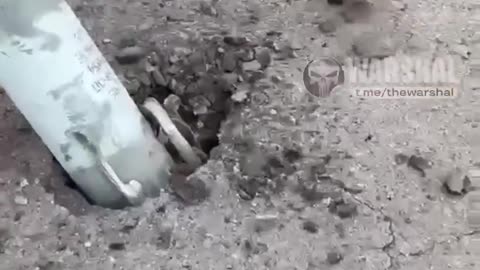 The Armed Forces of Ukraine are removing a part of an unexploded russian missile from the asphalt.