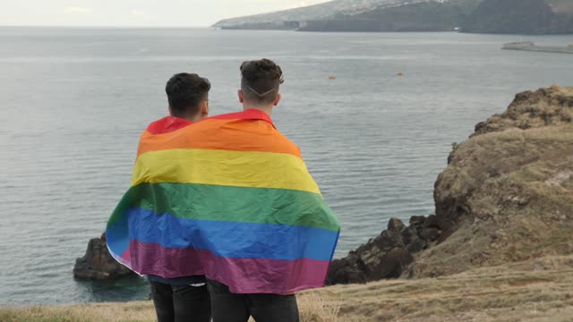 Gay couple wrapped in a pride flag