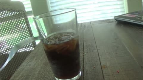 Fork scraping a glass of Dr Pepper