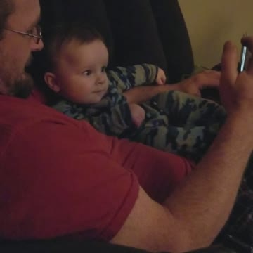 Baby finds his own video funny