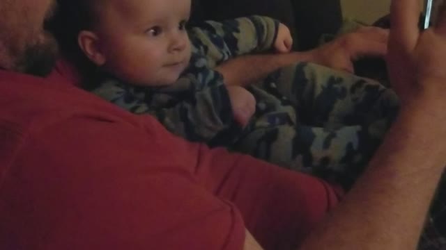 Baby finds his own video funny